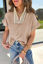 Beige pullover rolled short sleeve top with v-neckline and cream crochet lace accent trim