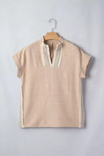 Beige linen pullover rolled short sleeve blouse with delicate cream crochet lace trim along neckline and seams