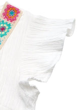 White trim v neck blouse with crochet trim and colorful patchwork details on ruffled sleeves and shoulder