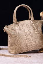 Beige crocodile-embossed leather handbag with dual handles and strap