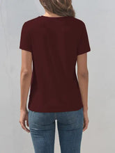 Woman’s short-sleeved cross graphic round neck maroon t-shirt and blue jeans