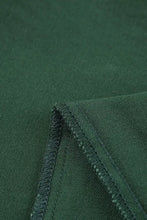 Dark green textured fabric with neatly stitched seam on crossed waist raw hem shift jeans material detail