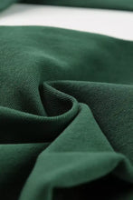 Deep green corduroy crossed waist raw hem shift jeans featuring distinct ribbed texture and stylish design