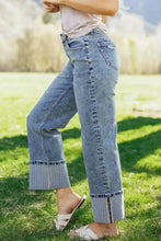 Cuffed straight loose high-waisted light blue denim jeans with rolled cuffs striped inner lining and zipper detail