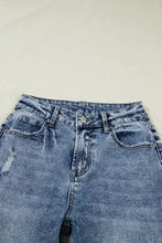 Light-wash denim cuffed straight loose jeans with a faded blue hue and subtle distressing details