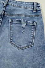 Medium-wash blue denim cuffed straight loose jeans back view with distressed frayed pocket and reinforced stitching