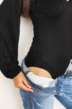 Blue denim jeans with distressed look and visible stitching paired with culture code full size v neck long sleeves bodysuit