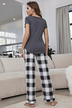 Black and white plaid relaxed fit pajama pants paired with a curved hem short sleeve top lounge set with sleeve length detail
