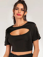 Black cropped tee with cutout grommet details and moderate stretch