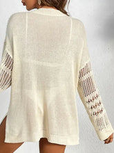 Cream-colored cutout notched long sleeve cardigan with open-knit design