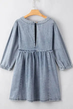Light blue denim dress with cutout round neck, long balloon sleeves, and gathered waist in soft denim fabric