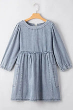 Light blue denim dress with cutout round neck, balloon sleeves, and gathered waist in long sleeve design