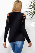Cutout round neck long sleeve black T-shirt with blue jeans