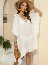 White ruffled crochet trim kaftan cover-up with V-neck, short sleeves, and cutout ruffled half sleeve design. Machine wash