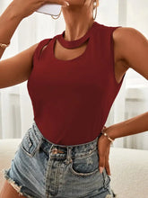 A fitted maroon cutout sleeveless tank top with high neckline and shoulder cutout details for stylish wear