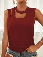 A sleeveless maroon cutout sleeveless tank top with a soft flowing fabric and a stylish neckline design