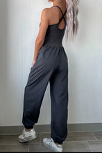Cutout square neck jumpsuit in charcoal gray with adjustable straps and pockets