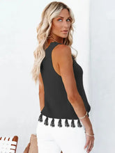 Black ribbed knit sleeveless round neck tank with cutout tassel round trim at the hem for stylish layering