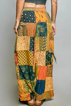 Pol printed patchwork wide leg pants in vibrant orange teal and gold with floral and geometric patterns and adjustable drawstring
