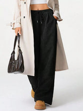 Black wide leg corduroy drawstring pants with elastic waistband for comfortable casual wear