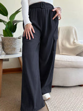 Black high-waisted wide-leg pleated trousers with belted waist and cargo pockets, machine wash and tumble dry safe