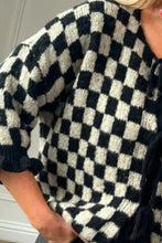 Pink and white checkered blouse with ruffled sleeves and lace-up front