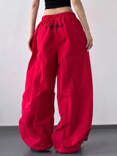 Vibrant red drawstring wide leg pants featuring loose fit and drag girl embroidered on the high waistband