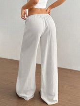 White wide leg drawstring casual pants with textured crinkled fabric and elastic waistband for comfortable wear