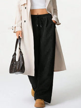 Black corduroy drawstring wide-leg pants with elastic waistband machine wash care instructions included
