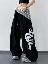 Black wide leg drawstring sweatpants with a white snake graphic and gray lace-trimmed waistband for casual wear