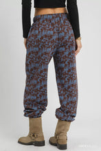 Umgee scenic print casual sweatpants featuring blue and brown patterned fabric with elastic waistband for comfort