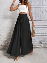 Black high-waisted frill wide leg pants with elastic waistband and drawstring for comfortable wear