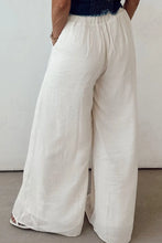 Wide leg white linen tie waist pleated pants with elastic waistband and subtle pleats for stylish comfort
