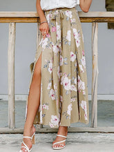 Beige floral wide leg pants with pink and white blossoms tied waist waistband and side slit detail