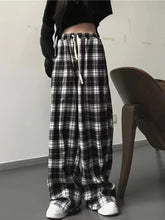 Black and white plaid high waist wide leg pants with elastic waistband and drawstring for comfortable fit