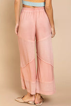 Soft pink pol elastic waistband wide leg pants with drawstring and subtle textured panels for a relaxed fit