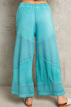 Turquoise pol elastic waistband wide leg pants with relaxed fit, contrasting textured panels, and ribbed cuffs