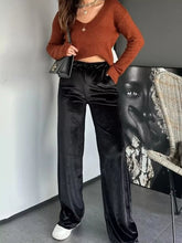 Black velvet wide leg pants with a flowy silhouette ideal for elegant and comfortable wear