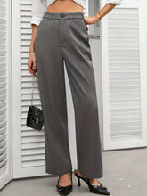Gray high waist wide leg trousers with tailored fit and buttoned waistband for a sleek formal look
