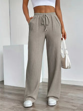 Beige texture wide leg pants featuring a drawstring waistband and a comfortable wide leg fit