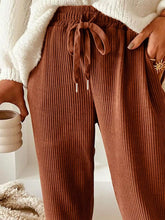 Casual corduroy drawstring waist pants in warm brown with vertical ribbed texture and adjustable drawstring waist