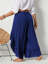 Plus size navy blue ruffled wide leg pants with an elastic waistband and a ruffled hem for a stylish fit