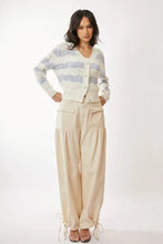 Blue and cream wave-striped pattern balloon sleeves neckline cardigan with beige wide-leg pants