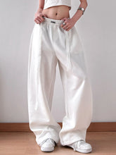 White wide leg pants with elastic drawstring waistband and subtle side stripes for comfortable wear