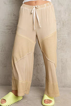 Beige pol elastic waistband wide leg pants with drawstring and textured fabric panels for comfortable wear