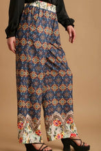 Umgee full size mixed print wide-leg trousers with elastic waistband in vibrant geometric and floral patterns on deep blue base