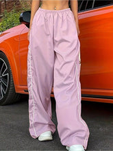 Light pink wide leg pants with elastic waist wide band and white side stripes for comfortable casual wear