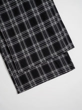 Black and white plaid fabric of relaxed fit plaid pants with a classic crisp pattern and comfortable design