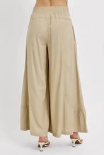 Beige risen shirring detail wide leg pants with elastic waistband relaxed fit and ruffled hem wide leg pants