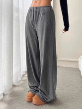 Gray relaxed fit drawstring pants made of soft fabric with an elastic waistband for comfort and casual wear